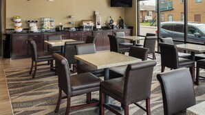 A modern restaurant with a bar area, seating, and a large window offering a view of the street. - Cobblestone Inn & Suites - Ashland (Ashland)