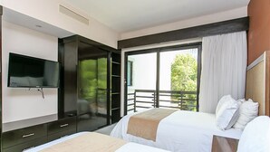 A hotel room with two beds, a TV, a sliding door to a balcony, and a large window with curtains. - Aldea Thai 32 by Tripintravel (Playa del Carmen)