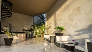 A modern lobby with a marble floor, a spiral staircase, and seating areas with potted plants. - Elements PH20 by Tripintravel (Playa del Carmen)