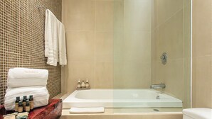 A modern bathroom with a glass-enclosed shower, a large bathtub, and a wooden vanity with toiletries. - Nolita 22 by Tripintravel (Playa del Carmen)