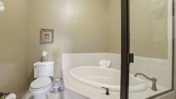 A bathroom with a toilet, sink, and bathtub.