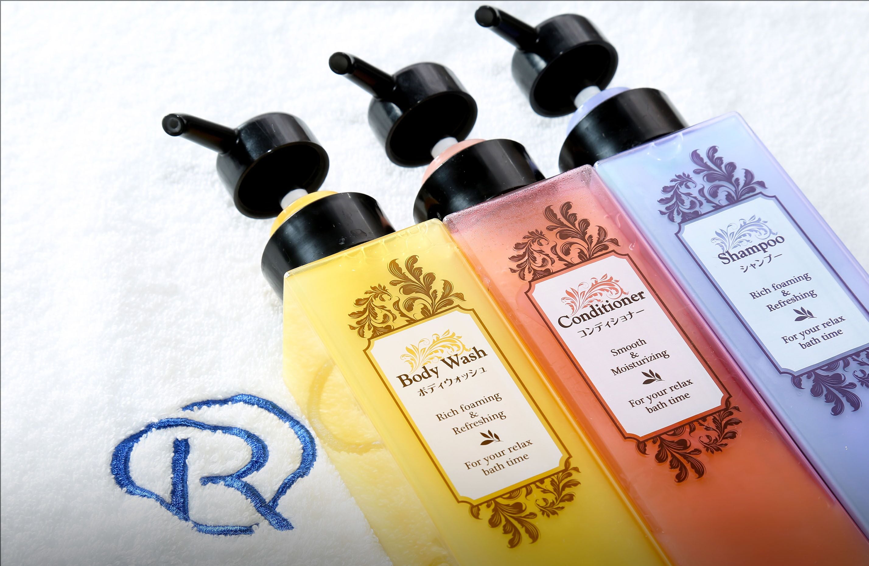 Four bottles of body wash and conditioner with labels.