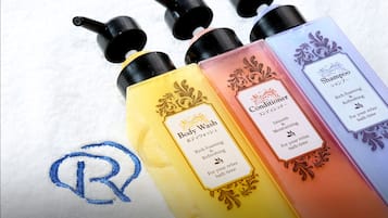 Four bottles of body wash and conditioner with labels.