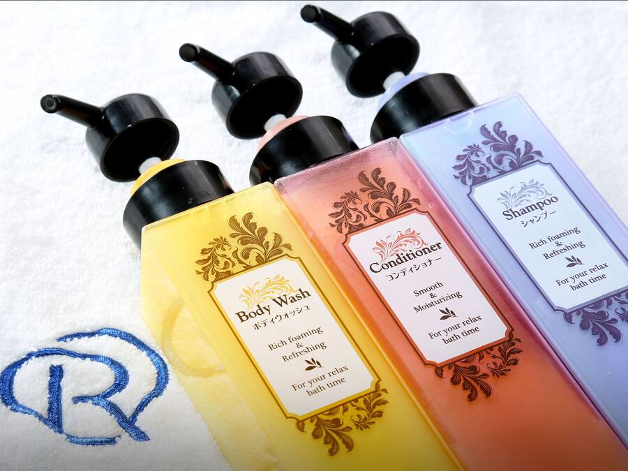 Four bottles of body wash and conditioner with labels.