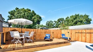 A backyard with a wooden deck, a pool, and outdoor furniture. - Hot Tub, Pool, Game Room & Mini Golf + 2 King Beds, Fun For the Whole Family! (Tampa)