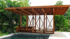 A wooden pergola over a swimming pool with a view of lush greenery. - BirdHouse@Gamboa, Panama Canal (Gamboa)