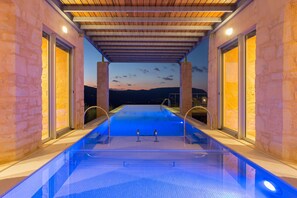 A heated pool, sun loungers