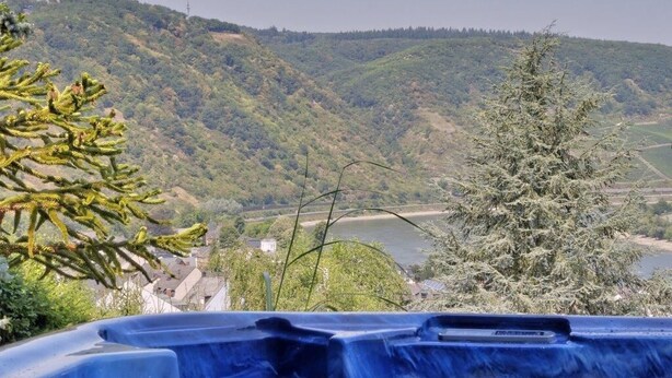 A hot spring area with a view of a lake and hills.