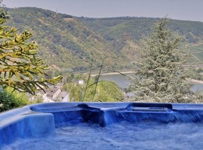 A hot spring area with a view of a lake and hills.