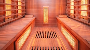 A sauna with wooden benches and a central ventilation grate.