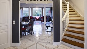 A grand staircase with a white balustrade leading to a second-floor landing.