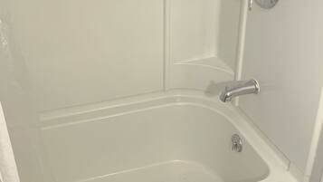 A bathroom with a bathtub, a shower, and a toilet.