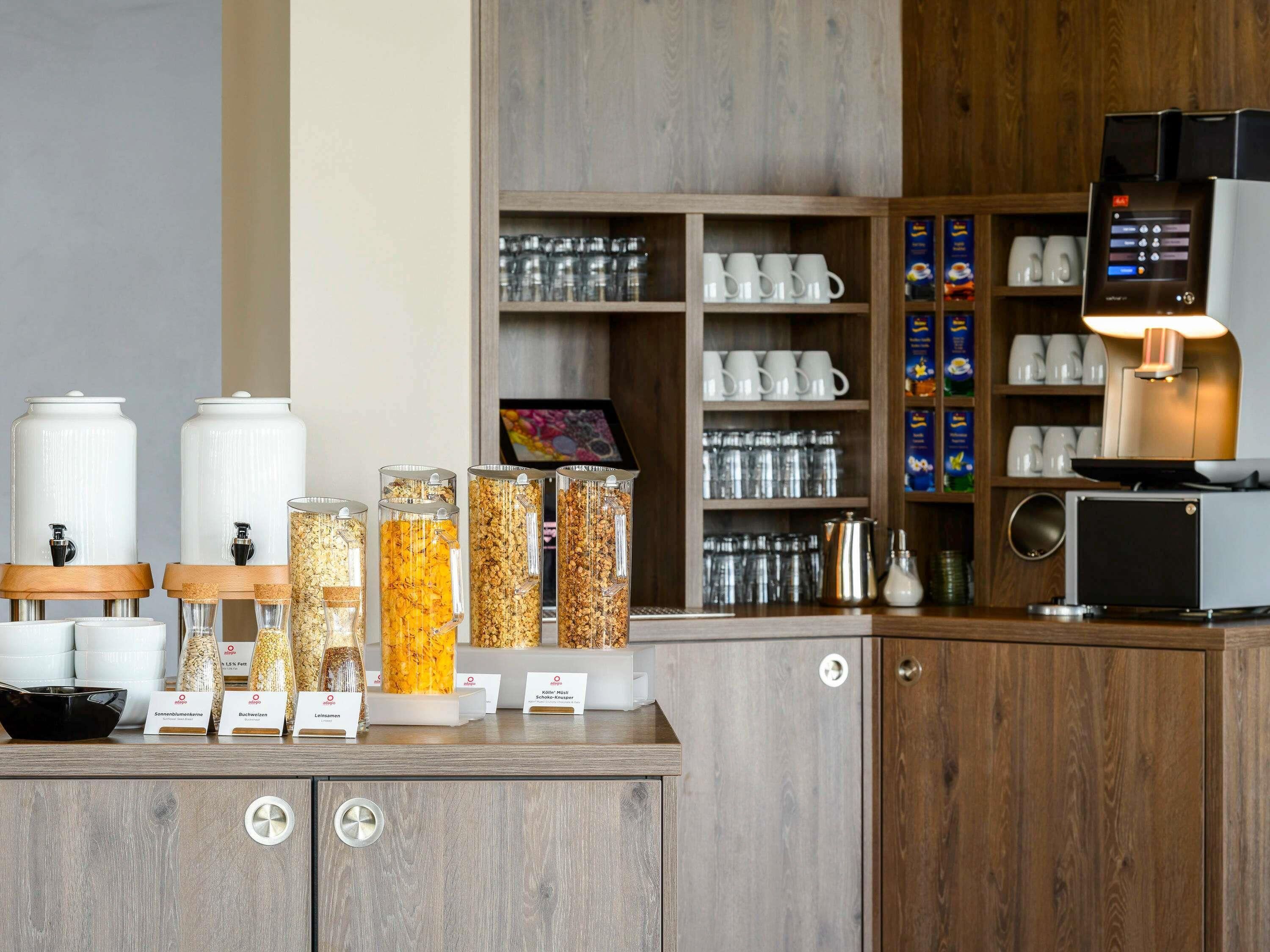 A coffee station with dispensers, a coffee machine, and a variety of coffee pods.