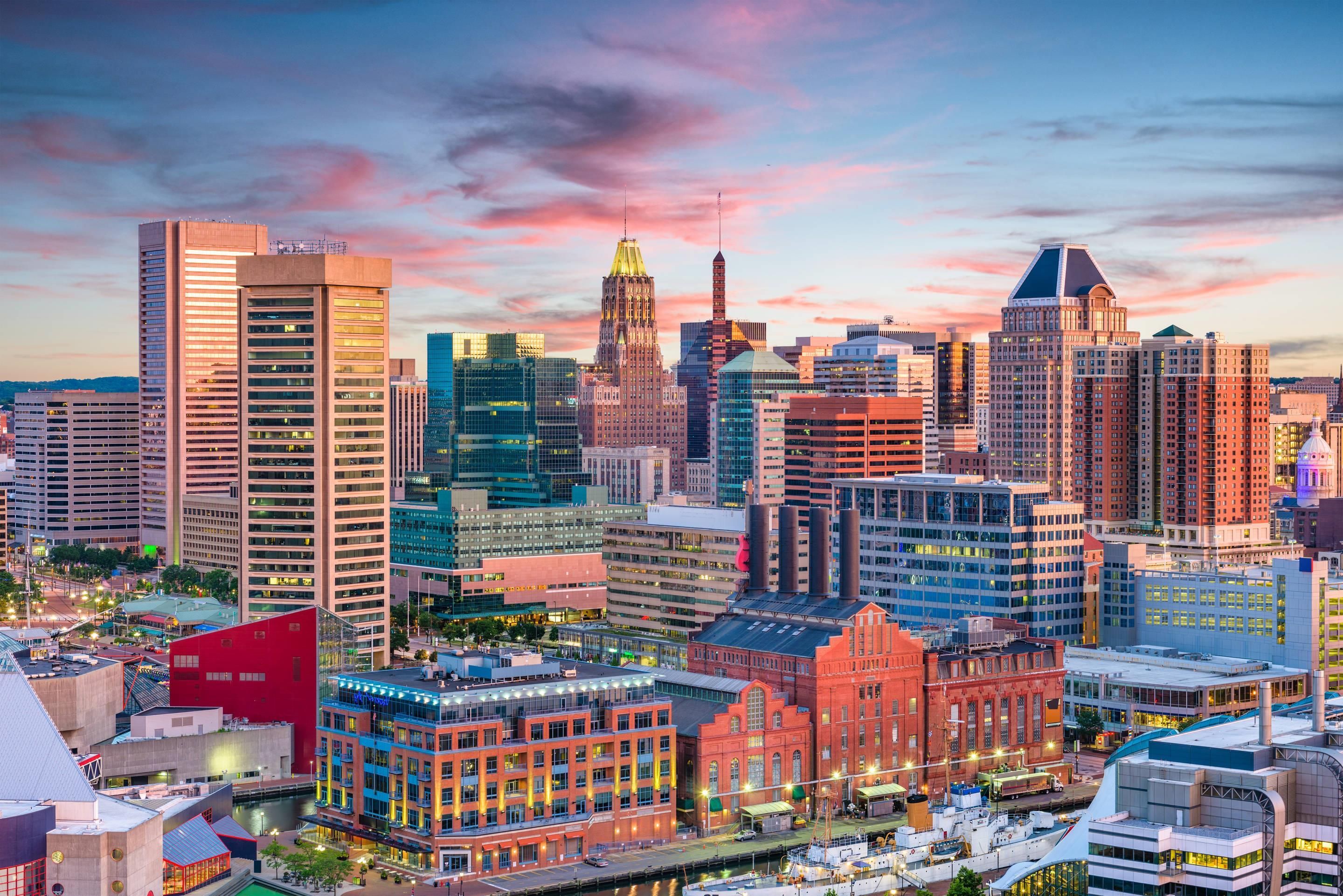 A cityscape with a prominent skyscraper and a historic building with a distinctive spire.