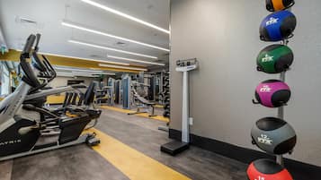 A gym with various exercise equipment, including treadmills and weight machines.
