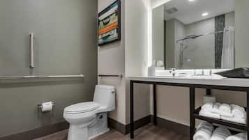 A modern bathroom with a toilet, sink, and towel rack.