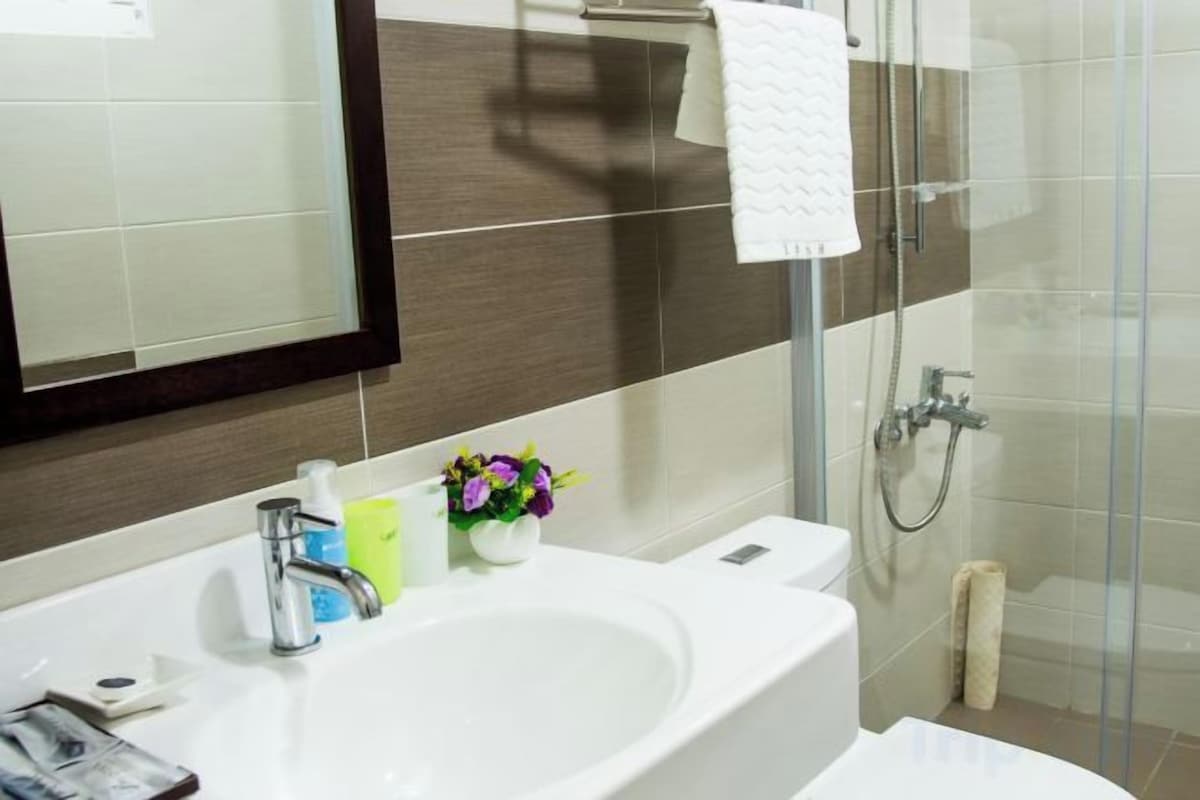 Bathroom | Shower, rainfall showerhead, hair dryer, slippers