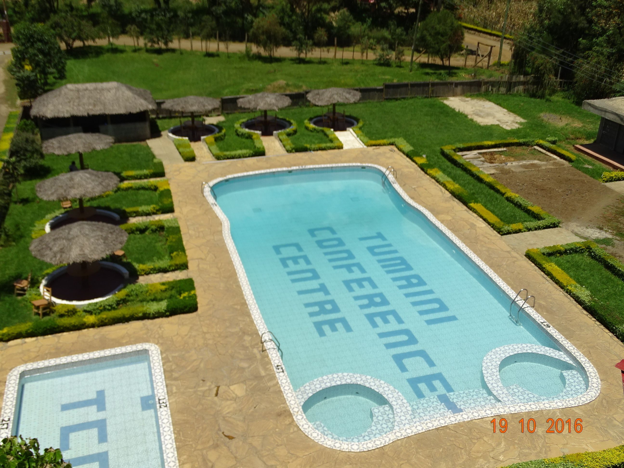 A swimming pool with the words "TUMAILI CONFERENCE CENTRE" and a date stamp "19 10 2016".