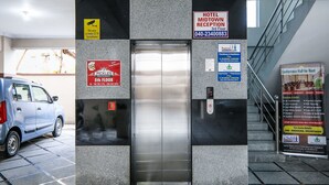 An elevator with signs for a hotel reception, a restaurant, and a conference hall for rent. - OYO 15928 Hotel Midtown (Hyderabad)