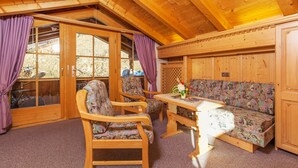 A wooden interior with a sofa, chairs, and a table. - Haus Hubertus (Reit im Winkl)