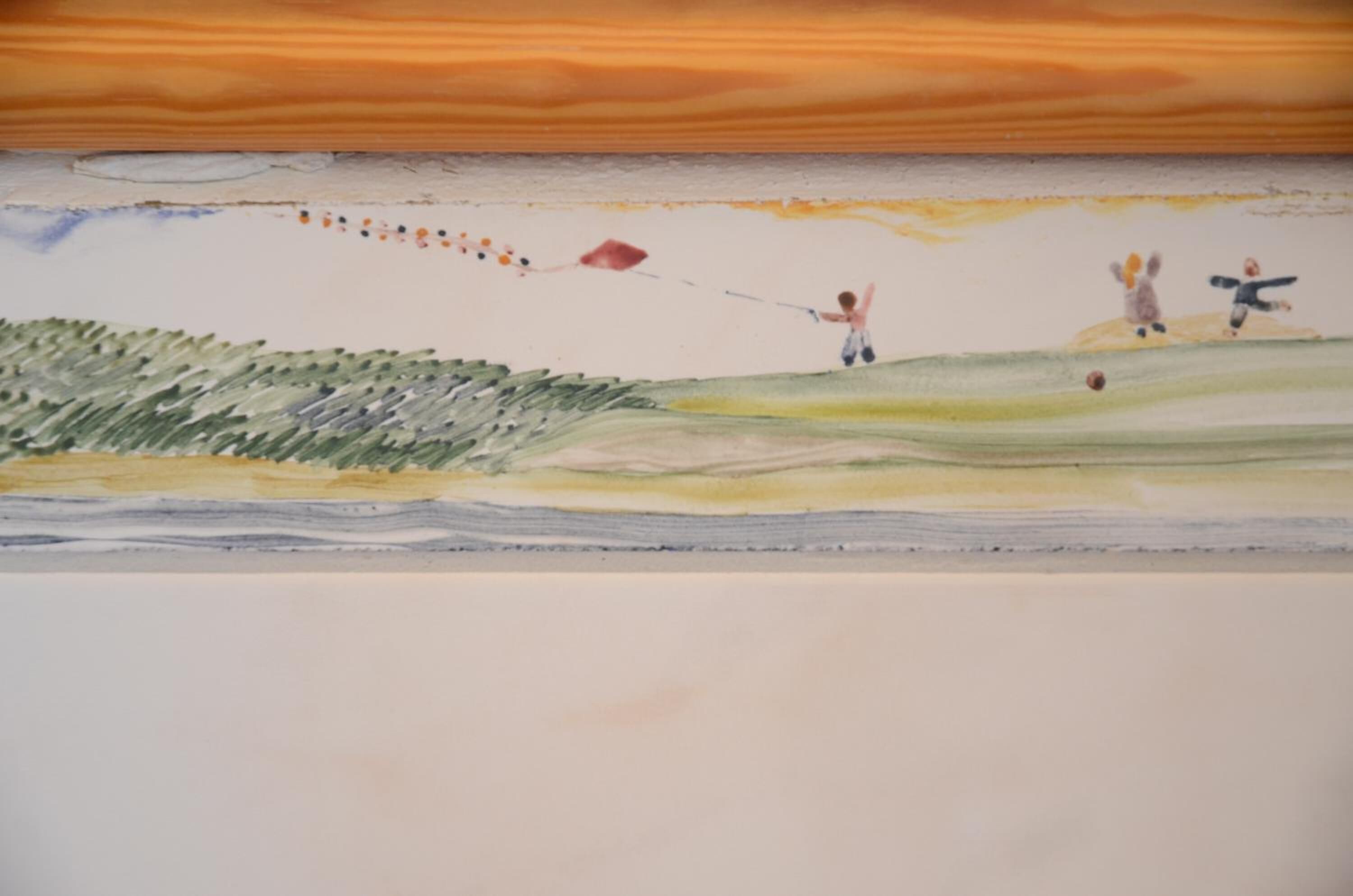 A painting of a child flying a kite on a grassy hill.