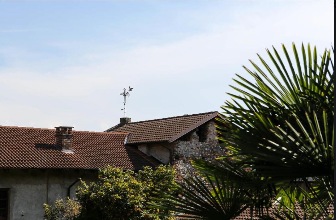 A rustic building with a tiled roof and a chimney.