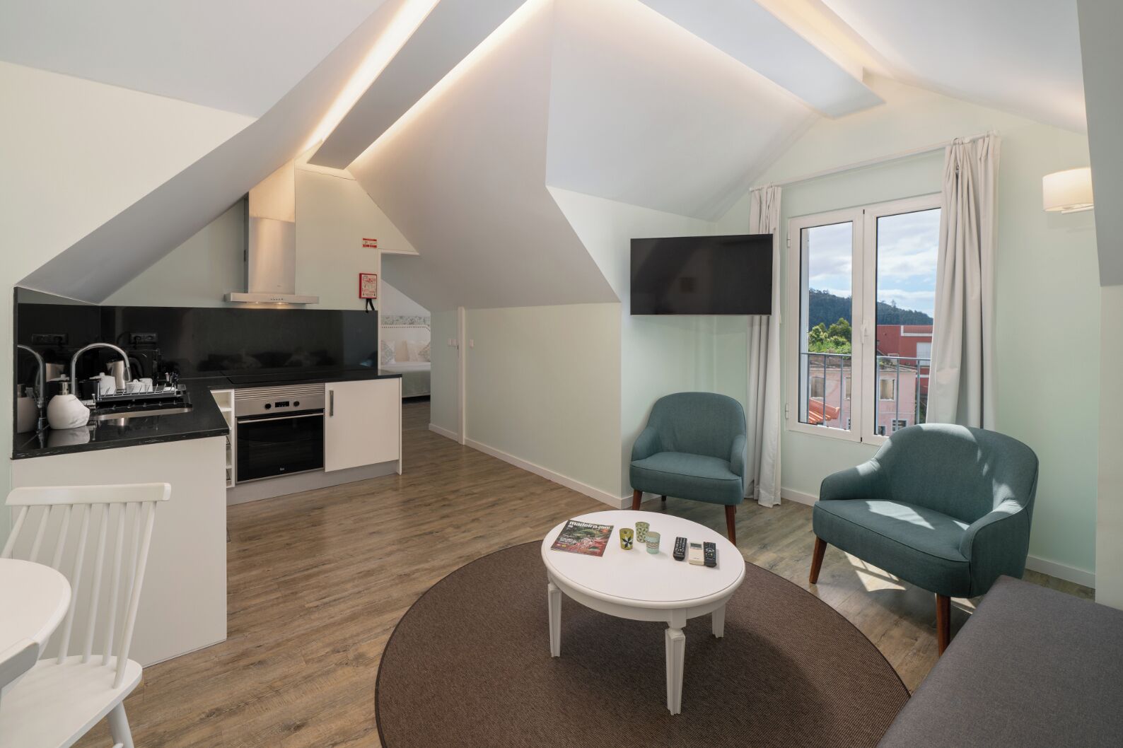 A modern apartment with a kitchen, dining area, and living room.