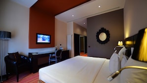 A hotel room with a bed, a desk, a chair, a television, and a mirror. - Nane Hotel (Gyumri)