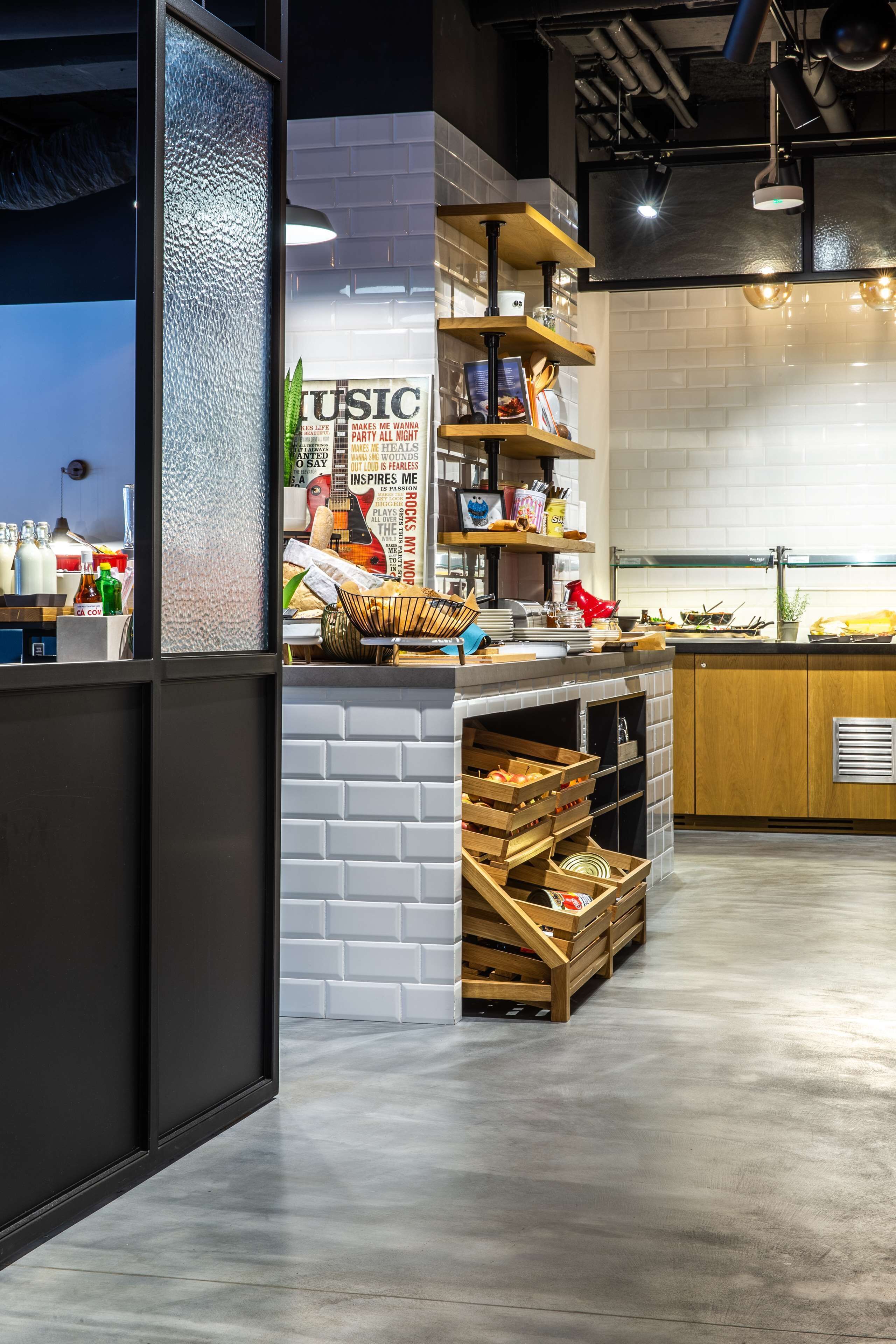 A modern kitchen with white brick walls, wooden shelves, and a built-in oven.
