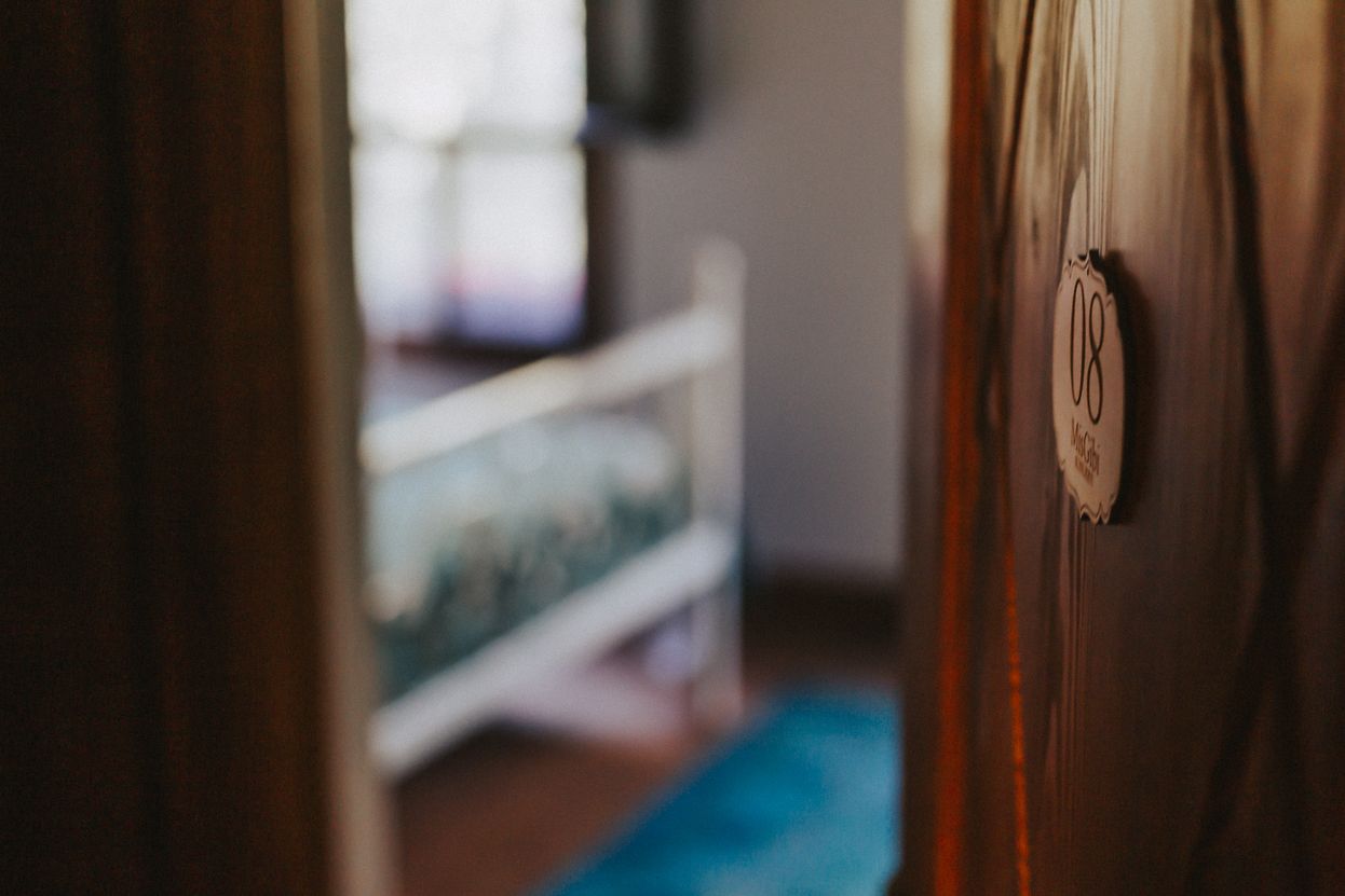 Una habitación con picaporte visible y una placa con número en la pared.