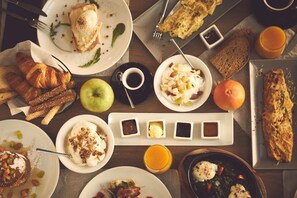 A breakfast buffet with various dishes, including pastries, fruits, and beverages. - The Artist Athens (Athens)