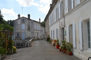 A narrow street lined with historic buildings, some with visible chimneys and windows.