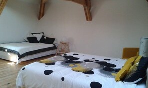 A bedroom with a bed, a small bedside table, and a lamp.