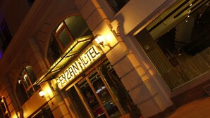 The exterior of the Feyzin Hotel with illuminated signage, a modern facade, and a visible entrance. - Feyzan Hotel (Corum)