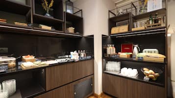 A buffet area with various food items and beverages.
