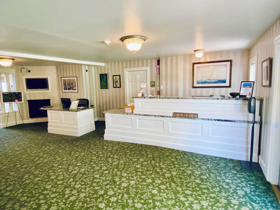 A reception area with a counter, a desk, and a door.