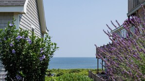 A pathway leading to a building with a view of the sea. - The 1661 Inn (Block Island)