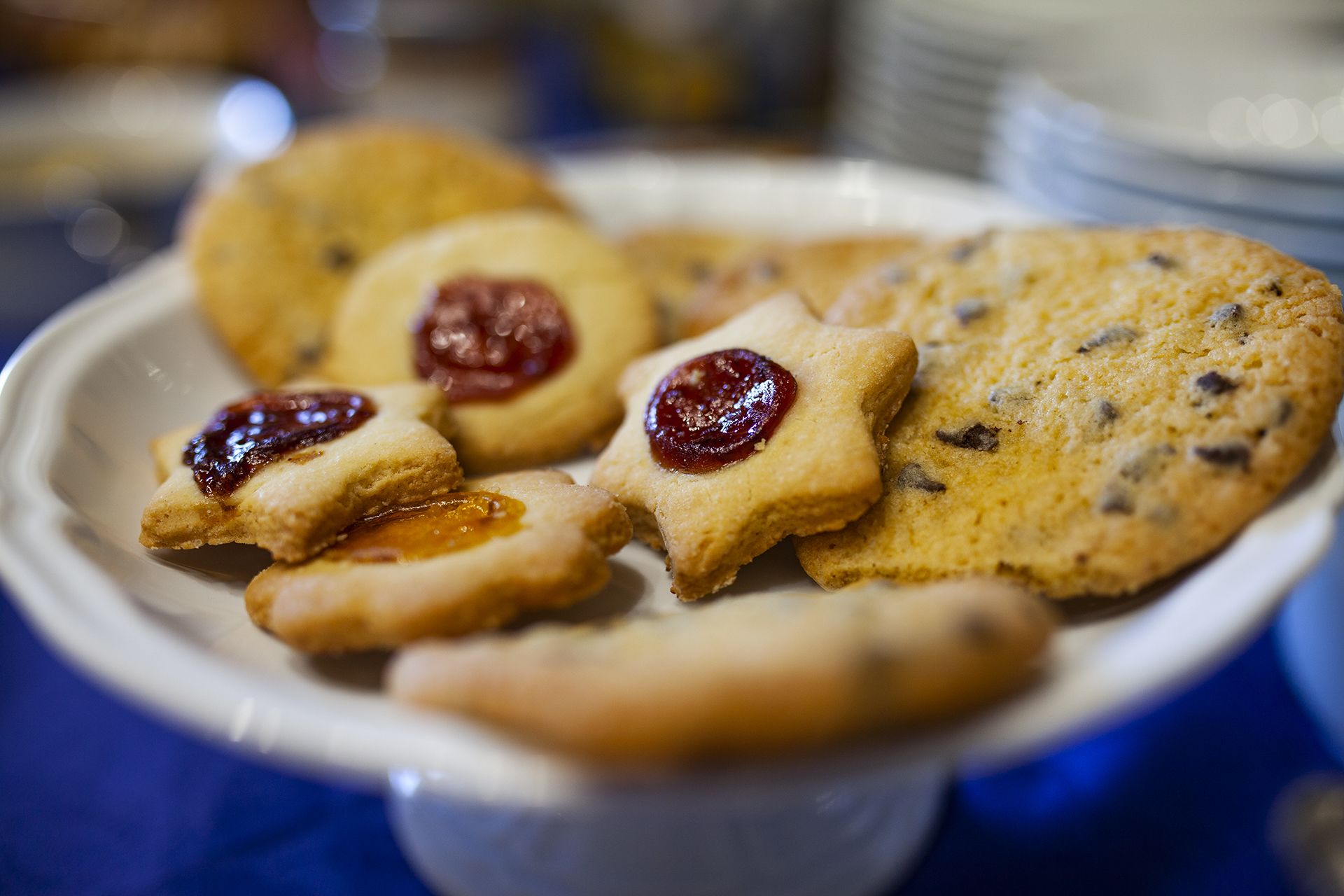 A plate of cookies with jam on top.