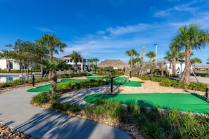 Enjoy a round of golf surrounded by lush greenery and palm trees on this well-maintained course.