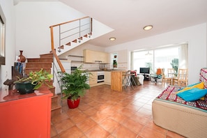 Living area with kitchen and dinning in the background 