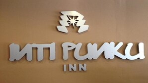 A hotel sign with the name "MTP PUNKU INN" and a stylized logo above it. - Inti Punku Alameda Inn (Machu Picchu)