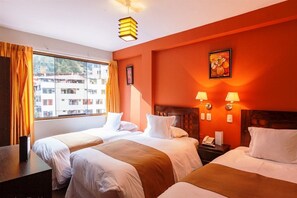 A hotel room with two beds, a window with curtains, a wooden headboard, and a painting on the wall. - Inti Punku Alameda Inn (Machu Picchu)
