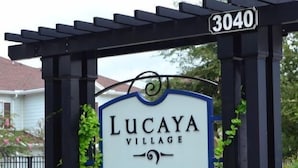 A sign for Lucaya Village with a street number 3040.