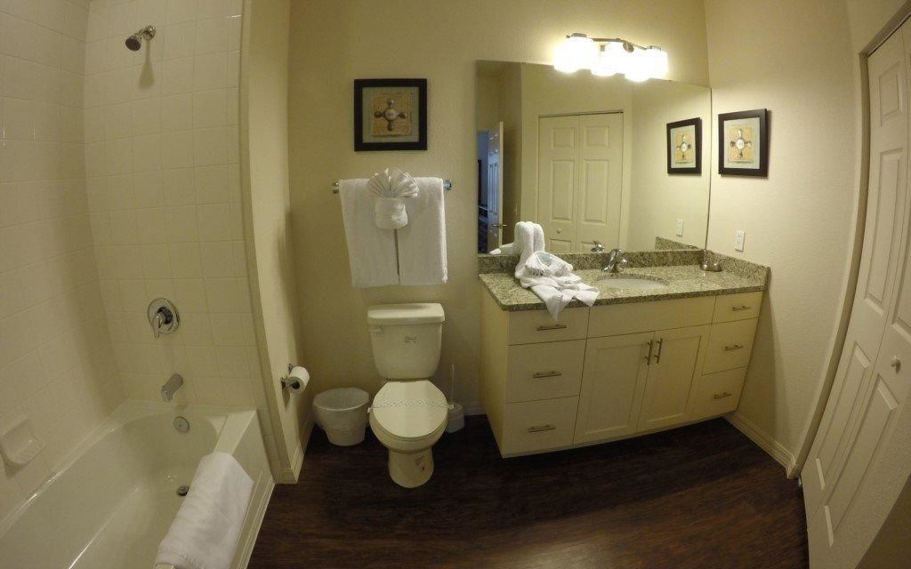 A bathroom with a bathtub, toilet, and sink.