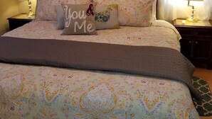 A neatly made bed with a patterned bedspread and multiple decorative pillows, including one with "You & Me" text. - 30+Day Stay⭐Lovely Smarthouse King 4KTV W/D WIFI (Klamath Falls)