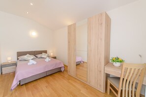 A bedroom with a bed, bedside tables, a mirror, a desk, and a chair. - Ivan's holiday house with private swimming pool (Klis)