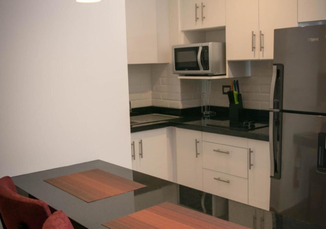 full-sized fridge, microwave, stovetop, coffee/tea maker