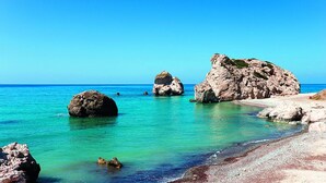 A coastal scene with clear turquoise water, rocky formations, and a sandy beach. - Mediterranean dream with sea view and private pool  (Pissouri)