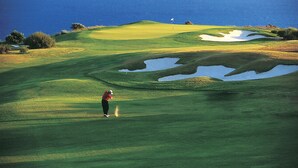 A golf course with a flag, sand bunkers, and a view of the ocean. - Mediterranean dream with sea view and private pool  (Pissouri)