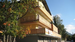 Ein zweistöckiges Gebäude mit einem Balkon im oberen Geschoss.